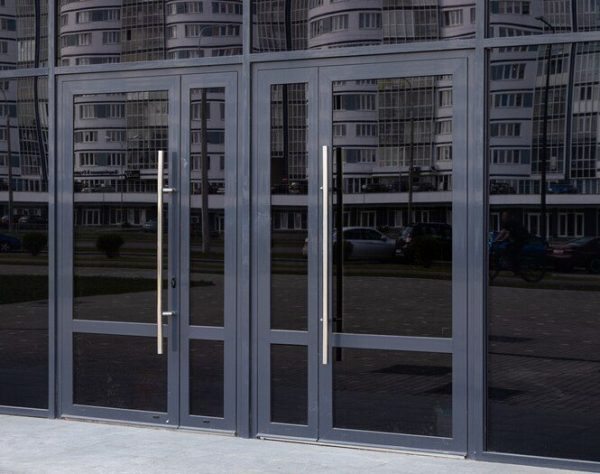 [onlinejsonformatter.com]-black-glass-doors-reflecting-block-flats-standing-opposite-side_88135-11882-medium